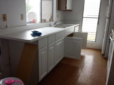 After a long day, the replacement of the kitchen cabinet was completed with a new sink, new cabinets and new countertop.